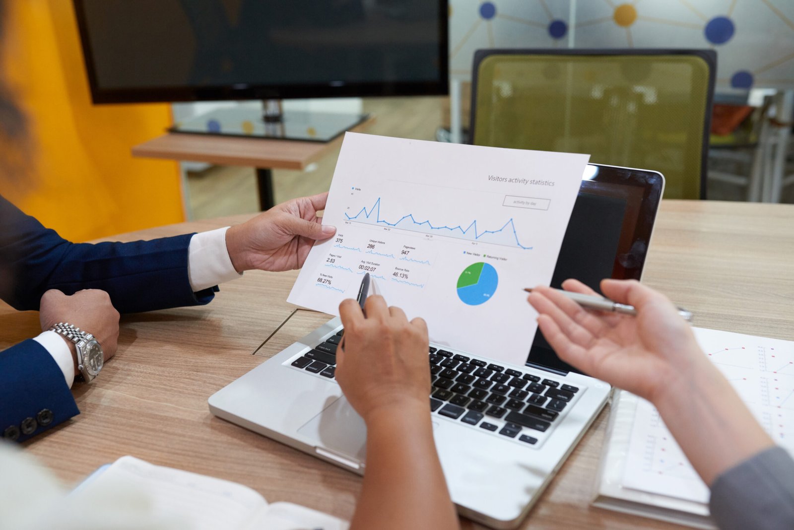 Close-up image of business executive discussing financial chart at meeting